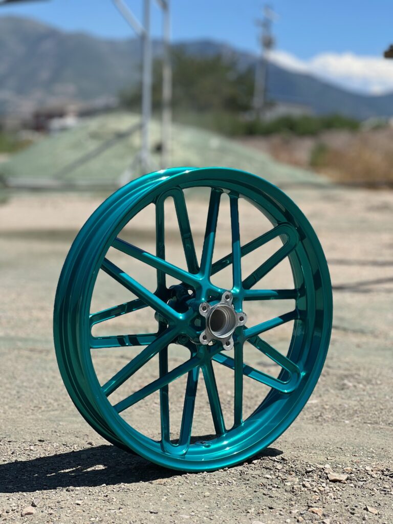 Wheel with a vivid teal powder-coated finish
