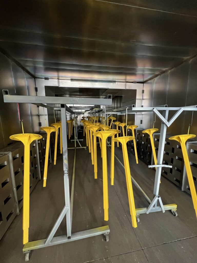 A room filled with yellow stools in the middle of it.