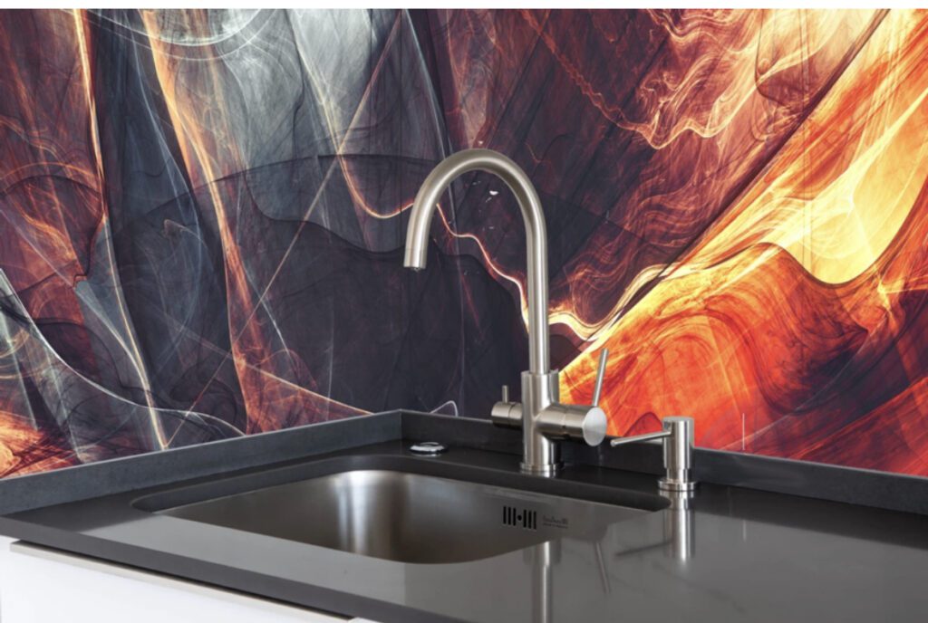 A sink with a black counter top and a red fire background